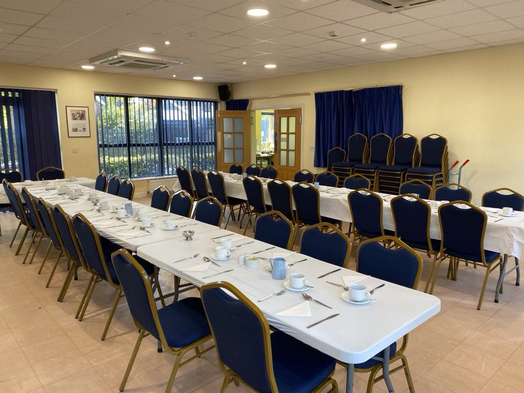 Tables laid for a meal in the hall