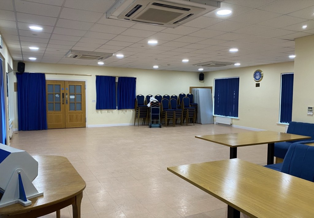 The main hall with chairs stacked at the side