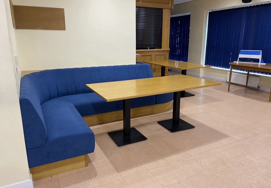 Booth seating and tables beside the bar